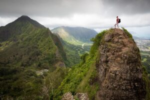 Leader standing on a mountain peak at sunrise, symbolizing alignment before success.
